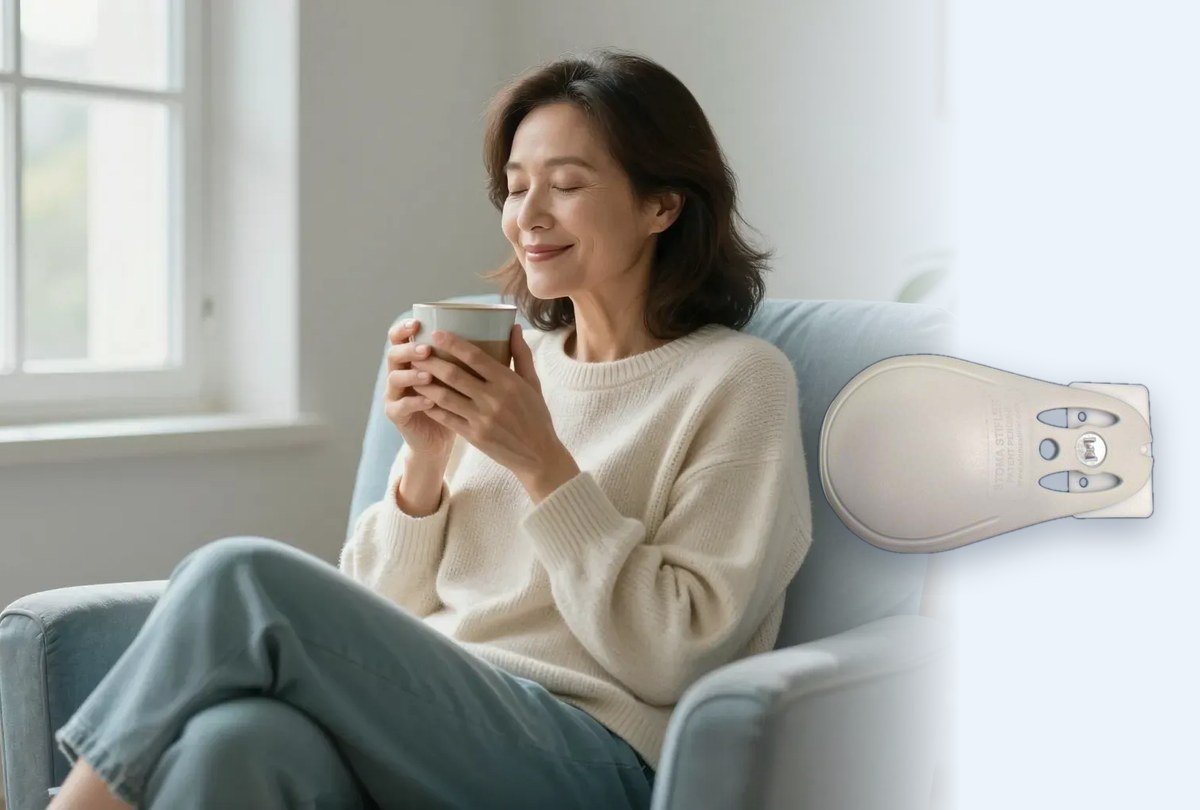 A woman relaxing at home with a cup of tea, beside the Stoma Stifler